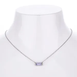 Detail shot of the dainty silver clavicle necklace featuring a sparkling purple rectangular zircon.