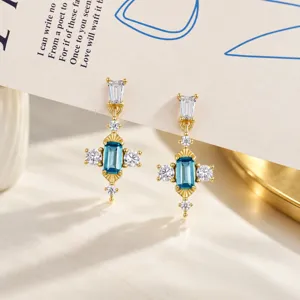 Vintage court style cross earrings with blue stone and gold plated s925 silver finish.