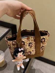 Stylish brown plaid tote bag with cute cartoon girl print and fluffy doll pendant.