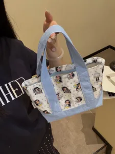 Canvas tote handbag with cute cartoon girl print, portable cosmetic storage pouch for daily use.