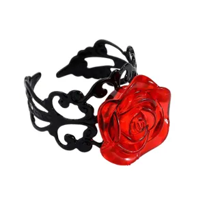 Detailed shot of a stylish red resin rose ring with black hollow-out adjustable band.