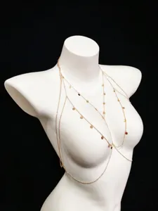 Detailed view of the multi-layer gold body chain with delicate sequin pendants for women.
