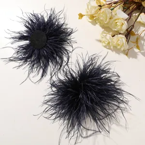 Close up detail of dark blue ostrich feather flower showing fluffy texture and backing.