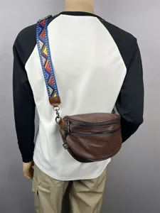 Men leather sling bag with colorful strap, double zipper retro crossbody bag for casual use.