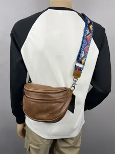 Detailed view of brown leather sling bag with colorful strap, retro design for casual daily use.