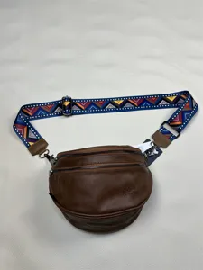 Stylish brown spherical shoulder bag with colorful woven strap, vintage casual crossbody bag.