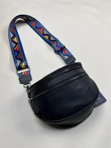 Threebox fashion black crescent crossbody bag with colorful woven strap for daily leisure.