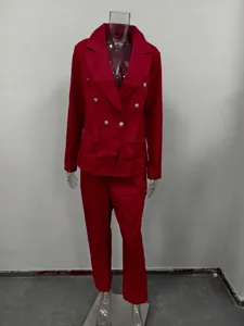 Detail view of the elegant red double-breasted blazer and trousers suit, fine texture.