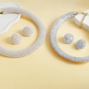 Close up details of exquisite pearl and sparkling rhinestone jewelry sets with matching earrings.