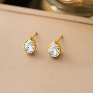 Elegant pear-shaped cubic zirconia stud earrings in gold tone, minimalist daily jewelry.