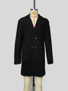 Details of the classic black double-breasted wool overcoat, showing lapel and button texture.