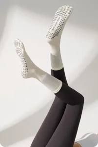 Non-slip five-toe yoga socks detail showing grip sole, comfortable cotton material for sports.
