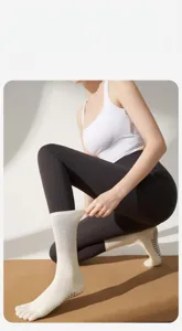 Detail view of anti-slip yoga five-finger socks, comfortable mid-tube compression.