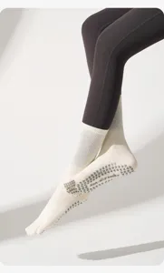 Detailed close-up shot of five-toe anti-slip yoga socks with grip dots for pilates fitness.