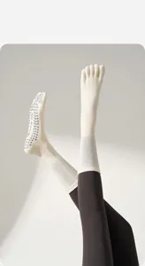 Anti-slip five toe yoga socks detail, soft cotton pilates socks with grey grip soles.