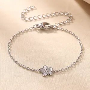 Pulsera de flores plateada con cadena fina y eslabón de extensión ajustable.