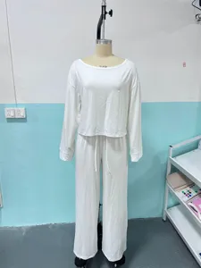 Off-shoulder long sleeve top and wide-leg pants set detail, elegant casual white outfit.