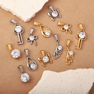 Detailed shot of stainless steel rhinestone pendants in various cute key and bow shapes.