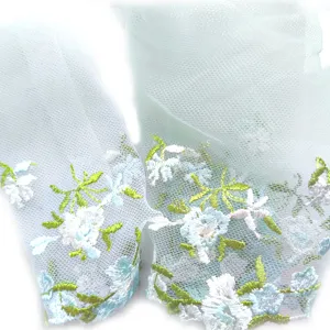 Delicate colorful floral embroidery mesh lace trim close-up detail for DIY apparel sewing.