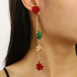 Detailed close-up view of the Christmas bow ribbon dangle earrings featuring red, green, and gold colors.
