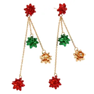 Detailed close-up of Christmas gift bow long dangle earrings, red green gold metal chain.