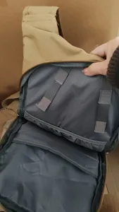 Detailed view of khaki tactical sling backpack interior with grey lining, compartments and velcro straps.