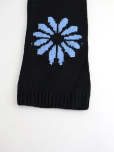 Detailed view of women's autumn winter knit sweater featuring chic floral pattern and ribbed cuffs.