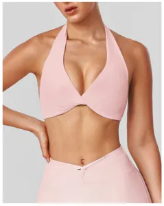 Pink halter yoga sports bra detail showing stylish front twist design and comfortable fit.