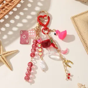 Pink and red crystal bead bag charm keychain with flamingo, playing card, dice and gold-tone accents