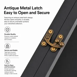 Close-up of an antique bronze metal latch with cross-head screws on a black record frame