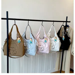Cinq sacs à motif de chien, en marron, bleu clair, rose, crème et noir, avec breloques