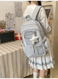 Élève portant un sac gris à étoiles, avec rayures, fenêtre transparente et pendentif étoile
