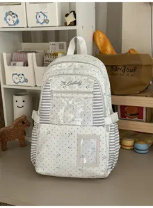 Face avant du sac avec poche zippée transparente, étoiles grises, côtés rayés et bretelles