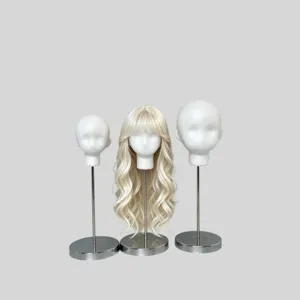 Three white foam display heads on silver stands, with a long blonde wavy wig on the center head