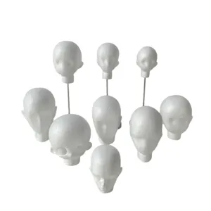 White foam mannequin heads in varied styles, including forms displayed on slender metal stands