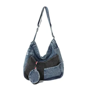 Patchwork denim shoulder bag with adjustable strap, metal hardware, and a round coin pouch