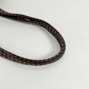 Close-up of a dark brown woven bag strap with a subtle plaid texture and stitched edges