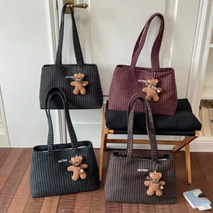 Four plaid tote bags in gray, burgundy, green and brown, each with a teddy bear charm