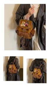 Model wearing a brown suede-texture backpack with a bear patch, buckle pockets and drawstring details