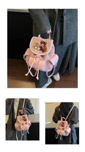 Three views of a pink velvet bag with teddy bear appliqué, flap, drawstring top and side pockets