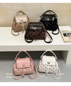 Five polka-dot suede bags in assorted colors, with heart clasps, drawstrings and shoulder straps