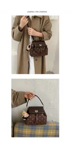 Brown dotted bag with heart-shaped clasp and teddy charm, shown worn crossbody and carried by hand