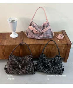 Three plaid shoulder bags in pink, brown and black, with buckle accents and curved top handles