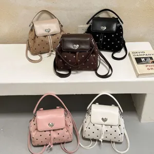 Five-color polka-dot convertible handbag backpack with faux suede panels and a heart-shaped clasp