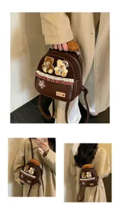 Brown bag shown handheld, crossbody and on the back, with teddy and bread plush patches and trim
