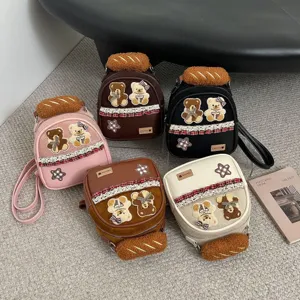 Five small teddy-patch backpacks and shoulder bags in pink, brown, black, coffee, and cream