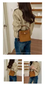 Brown suede-textured bag with leather trim and gold clasp, shown worn with a casual outfit