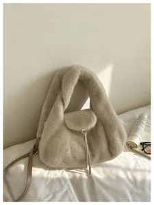 Beige faux-fur bag displayed in soft sunlight, with a slim leather strap and metal detail