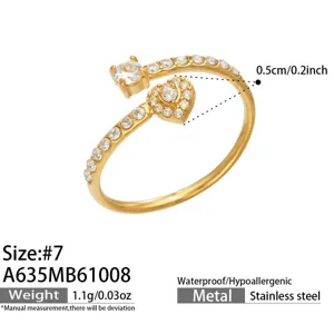Close-up of a gold-tone open ring with clear zircon stones and a heart-shaped pavé detail