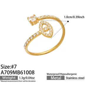 Close-up of a gold-tone open ring with a round clear stone and leaf-shaped pavé setting, size #7